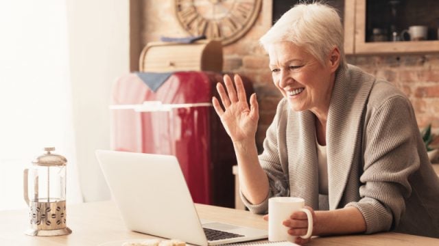 Woman waving using a video chat